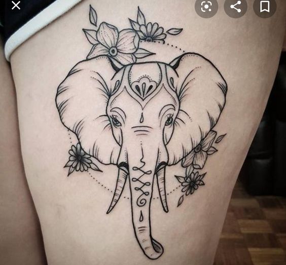 Elephant head tattoo on thigh.