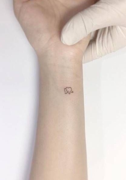 Extremely small elephant tattoo on wrist.