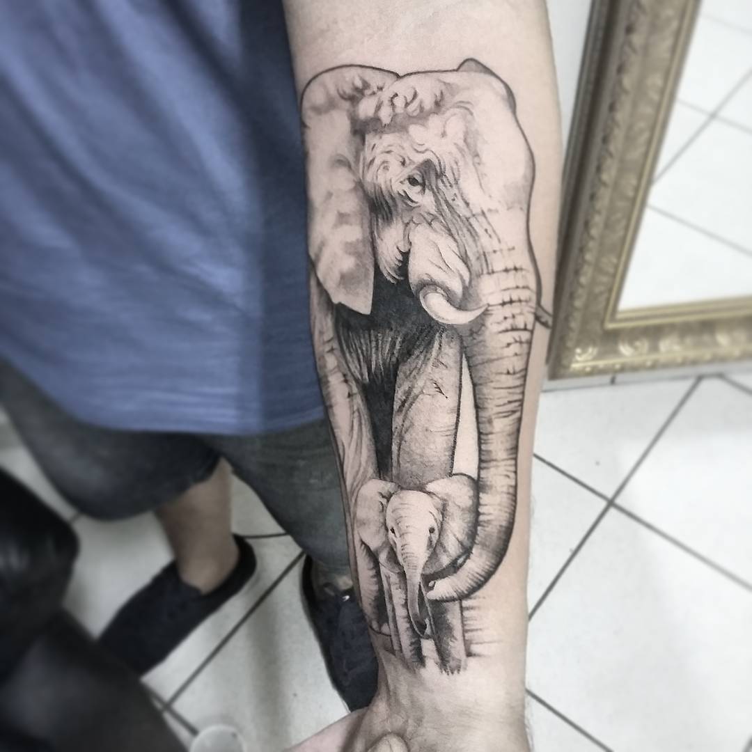 Father- son elephant tattoo on arm.