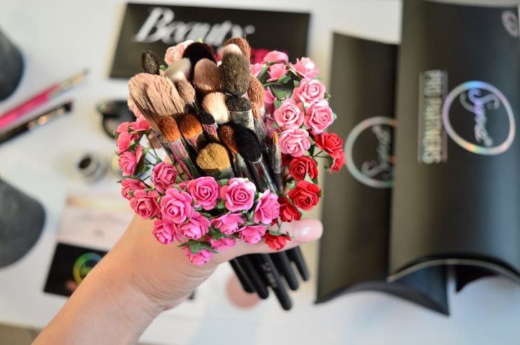 Flowers with makeup brushes.