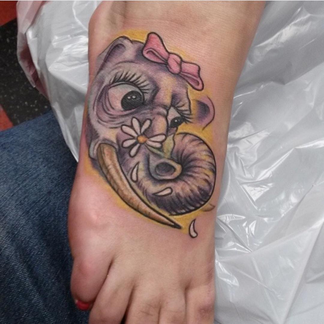 Girly elephant tattoo on foot.