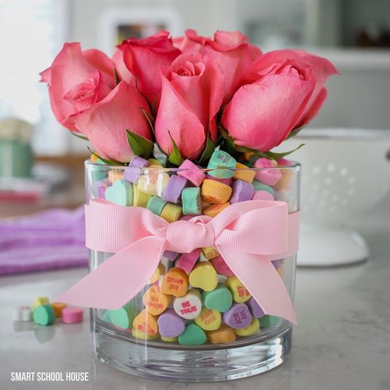 Rose bouquet surrounded by conversation hearts.