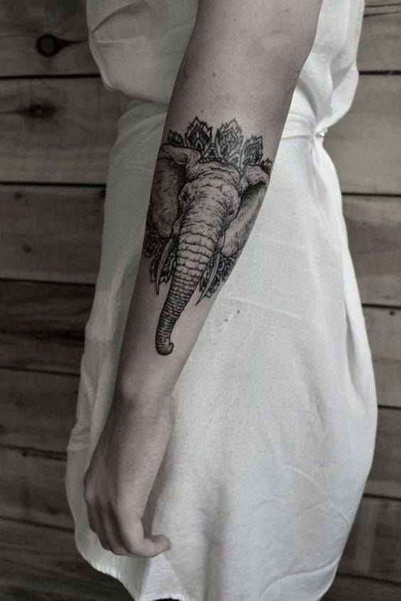 Tribal elephant tattoo on forearm.