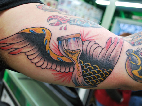 Amazing arm hourglass tattoo.