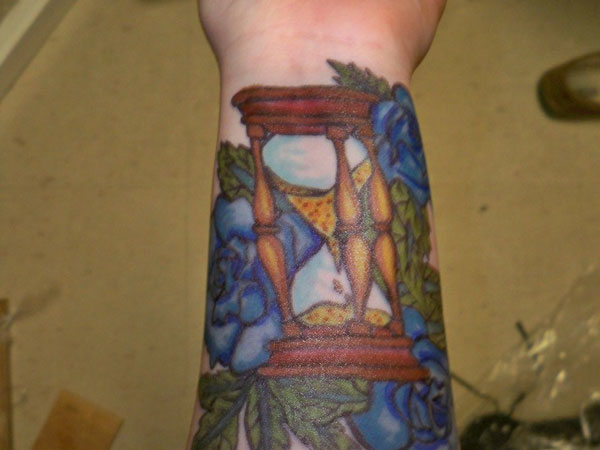 An hourglass on the wrist beating with the pulse symbolizes that time is passing away with each beat.