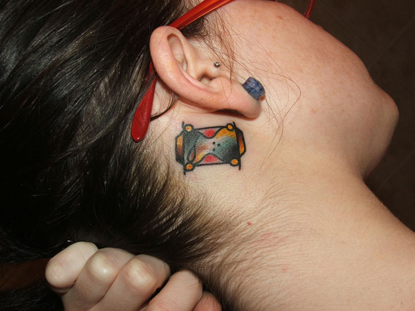 Behind the ear hourglass tattoo.