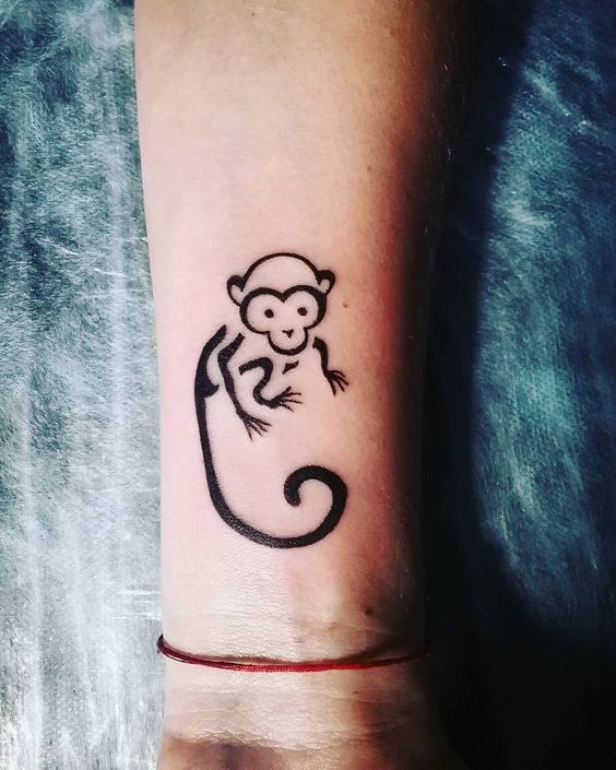 Black continuous baby monkey tattoo on wrist.