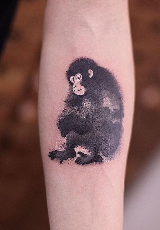 Black monkey tattoo on lower leg.