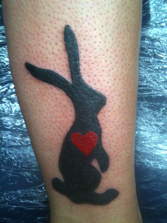 Black rabbit heart tattoo.