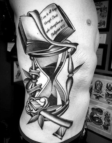 Book and key hourglass rib tattoo.