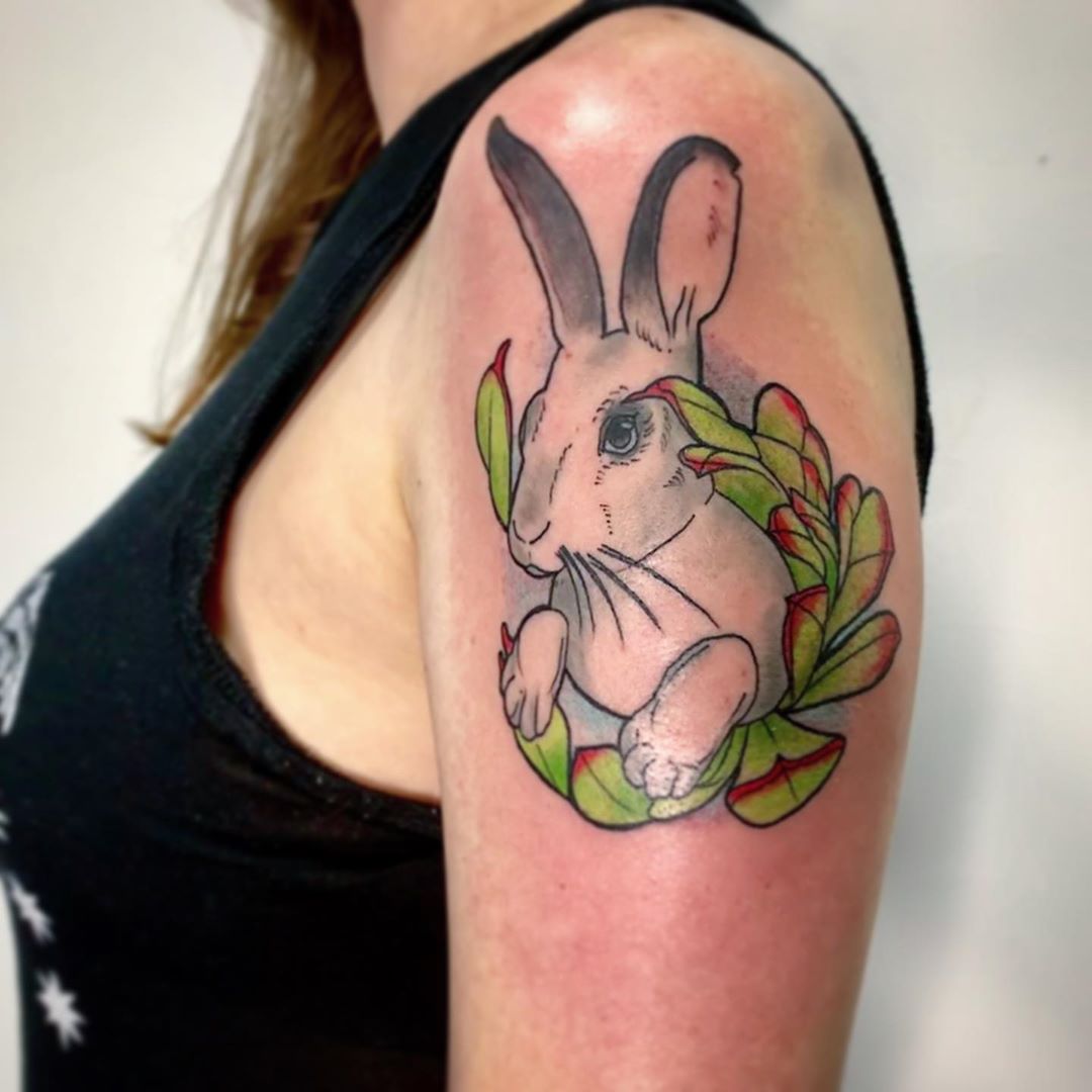 Bunny with succlent on upper arm.