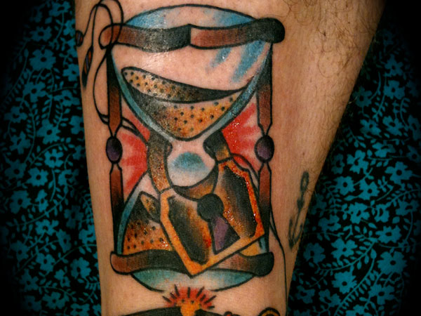 Chic forearm hourglass tattoo.