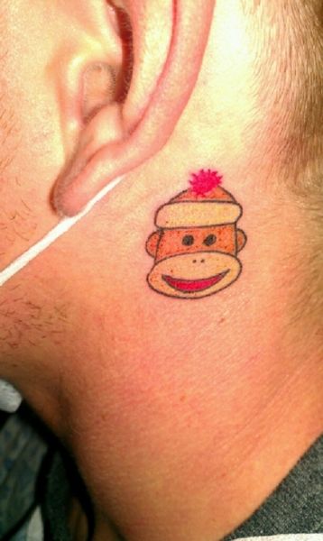Chic small tattoo behind the ear.