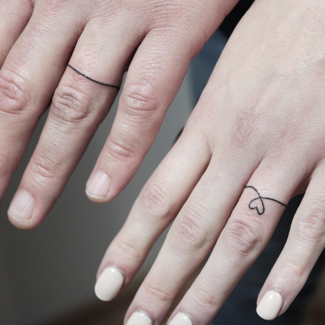 Cute line wedding ring tattoo for couple.
