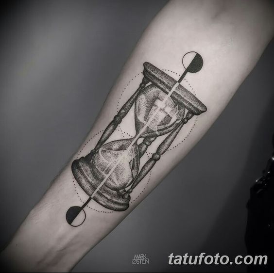 Dot work hourglass tattoo on forearm.