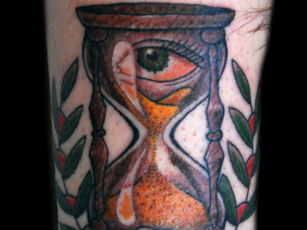 Eye with hourglass symbolizes the importance of sticking to schedules and being on time.