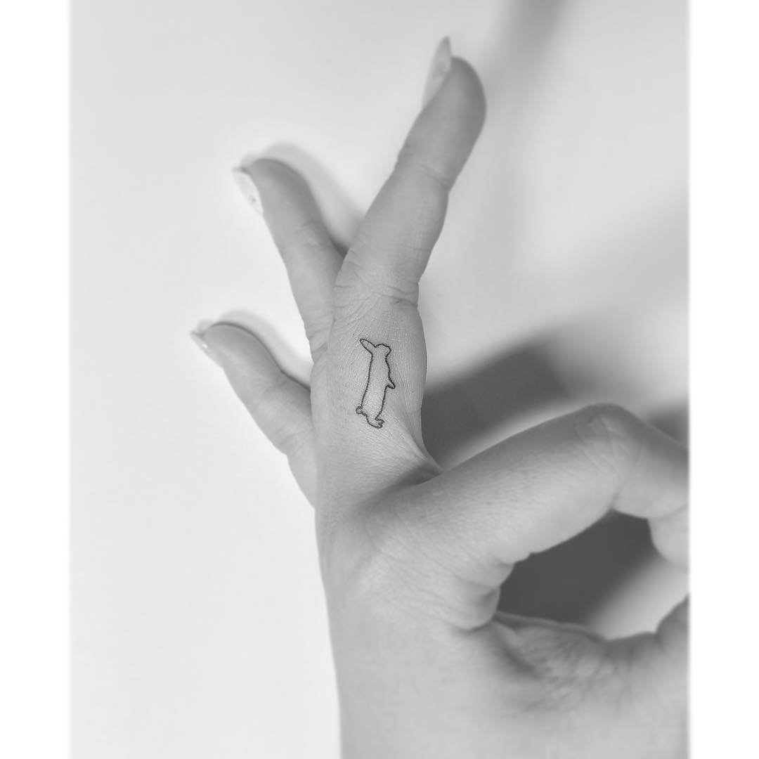 Finger rabbit tattoo.