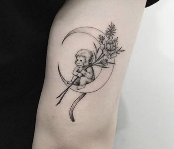 Gorgeous monkey tattoo on crescent moon.