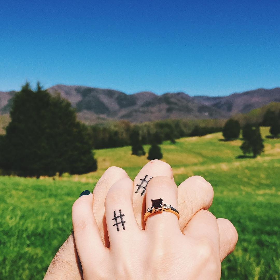 Hashtag wedding ring tattoos for couple.