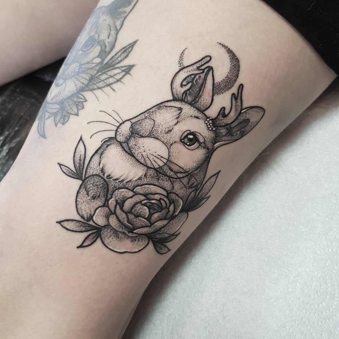 Lovely bunny tattoo with rose.