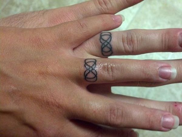 Matching band tattoo with infinity symbols.