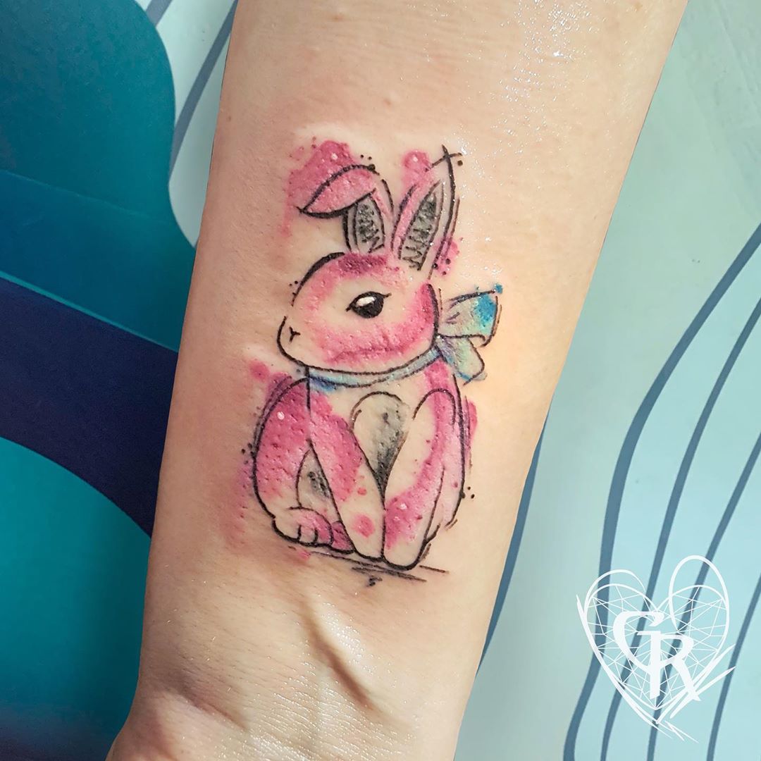 Pink bunny tattoo on wrist.