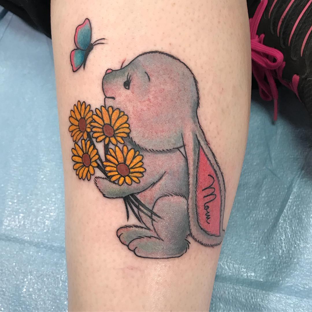 Sassy bunny tattoo with sunflowers and butterfly.