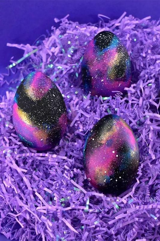 Sassy galaxy Easter egg with gold glitters looks like stars.