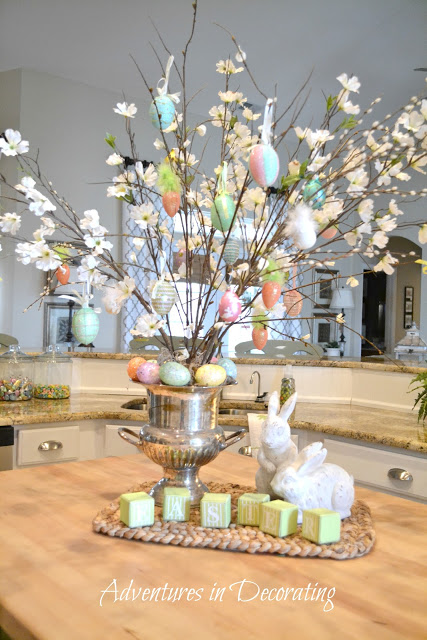 Silver bucket filled with branches and decorated with eggs.