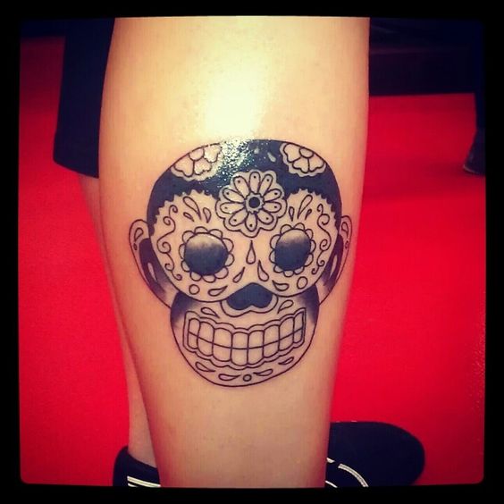 The candy skull tattoo of a monkey.