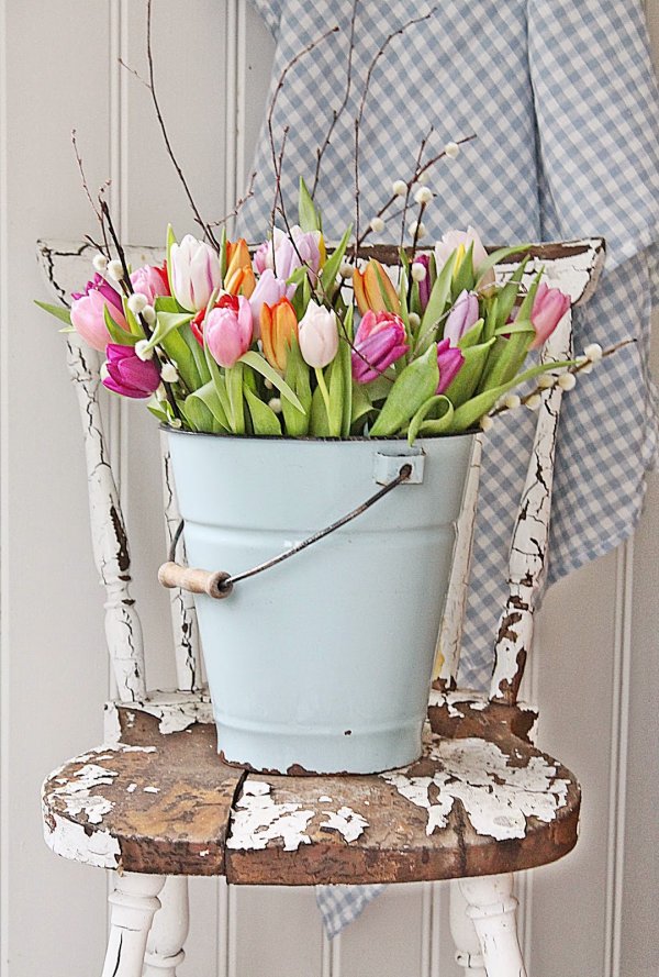 Tons of tulips in galvanized bucket.