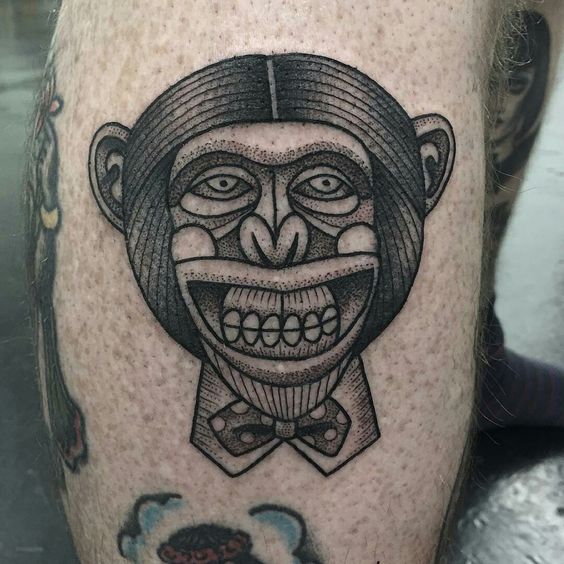 Tribal monkey tattoo with big smile.