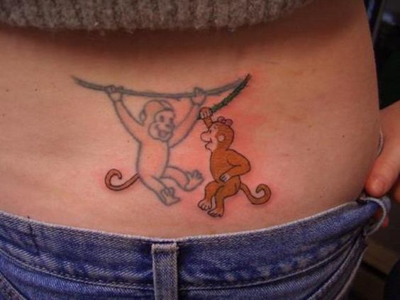 Two monkeys tattoo hanging on the back.