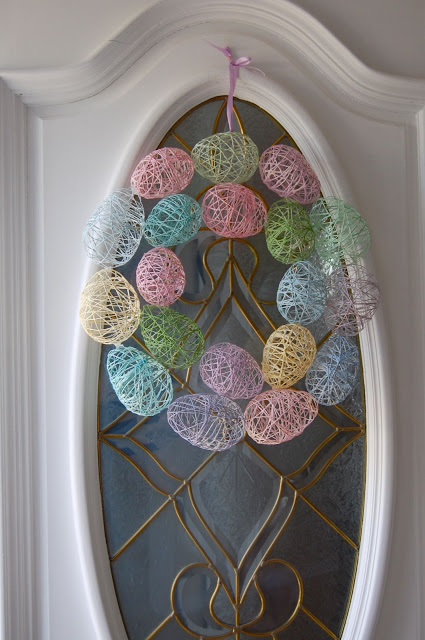 Yarn egg wreath for front door decor.